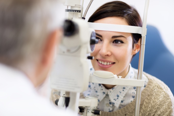 Woman look in ophthalmoscope